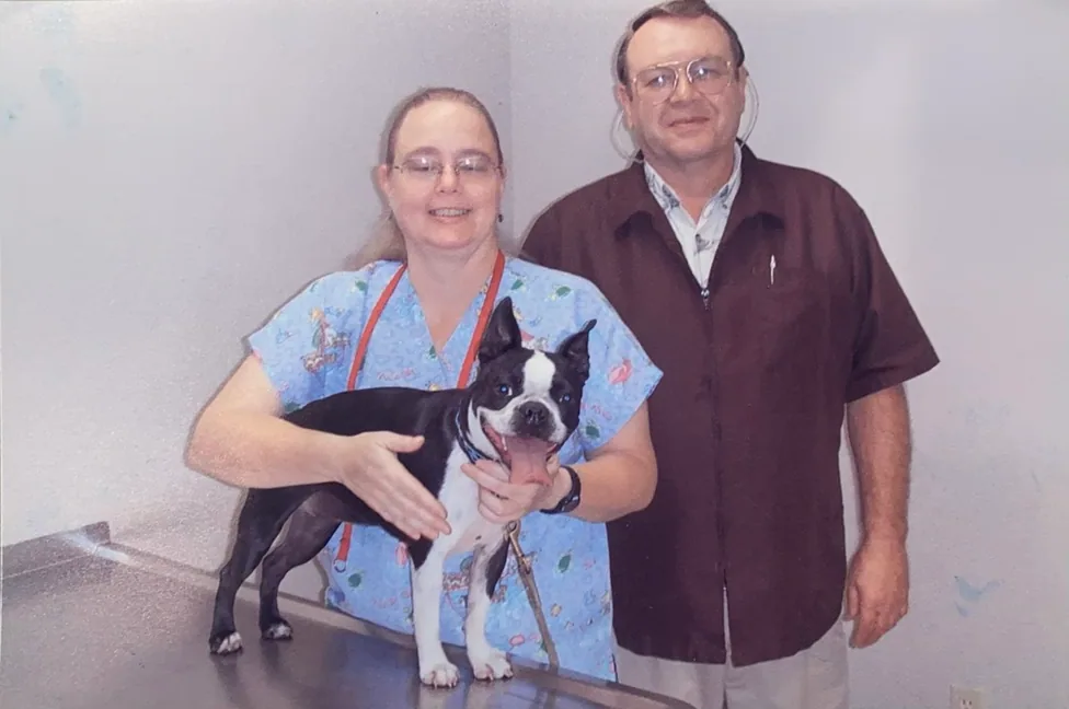 Dr. Gregory and a vet tech with a dog in an exam room.